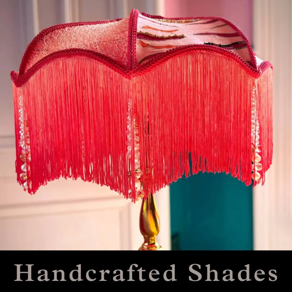 A coral and peach lampshade with a deep fringe and jewelled tassels. 