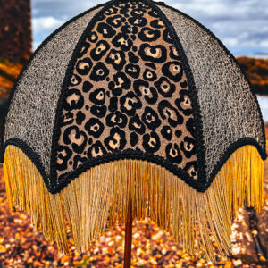 Large leopard lampshade set against a Scottish landscape
