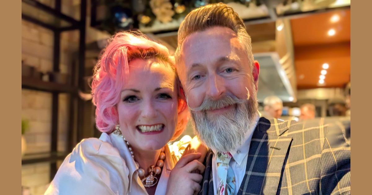 A woman and a man posing for the camera.